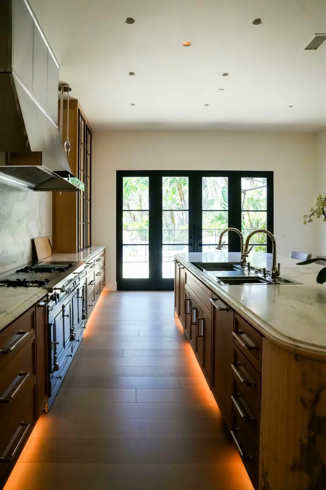 Kitchen with island, range, and dark hardwood floor after complete remodel
